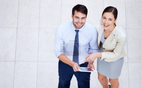 Photo for Theyre pleased with their careers. High angle portrait of two young business colleagues standing with a digital tablet - Royalty Free Image