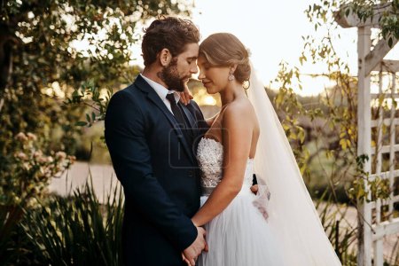 Photo pour Wedding, love and bride with groom in garden for marriage, ceremony celebration and commitment. Romantic partners, trust and bridal couple hug, embrace and happy for romance, calm and peace in park. - image libre de droit