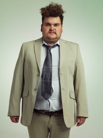 Téléchargez les photos : How do I look. Studio shot of an overweight man wearing badly fitting clothing - en image libre de droit