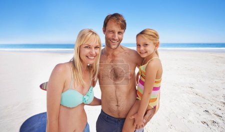 Foto de Fun times as a family. Portrait of a happy family of three having fun on the beach - Imagen libre de derechos