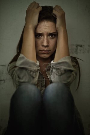 Photo for Overcoming her own demons. A young woman looking anxious and fearful - Royalty Free Image