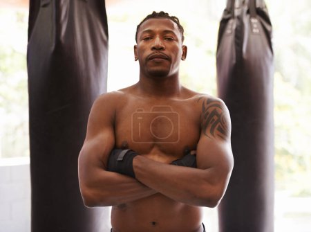 Photo for All power and muscle. Portrait of a young boxer standing in a gym - Royalty Free Image