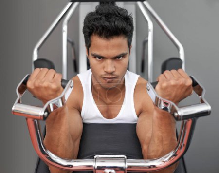 Photo for Hes always in the gym. A young ethnic man exercising in the gym - Royalty Free Image