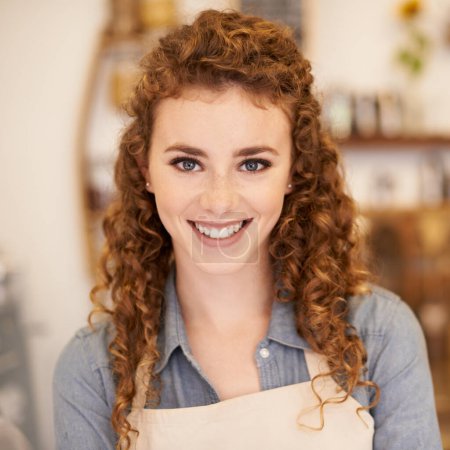 Photo for Beautiful barista ready to take your order. Closeup portrait of an attractive young barista standing in a cafe - Royalty Free Image