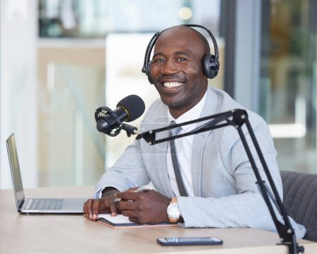Portrait, laptop and news with a black man radio presenter writing in a notebook during a live broadcast. Computer, podcast and microphone with a male journalist working in media for a talk show.