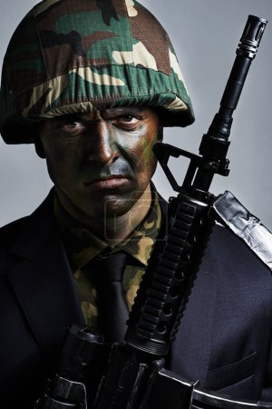 Photo for Ready for a battle. A young military man wearing camouflage facepaint - Royalty Free Image