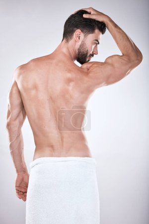 Photo for Back, cosmetics and man cleaning, wellness and body care on grey studio background. Skincare, male or gentleman with dermatology, natural beauty and self care for hygiene, grooming or morning routine. - Royalty Free Image