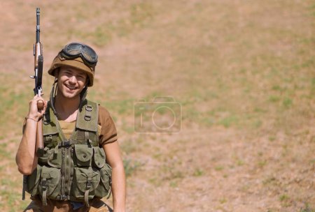 Photo for Defending his country. A handsome soldier smiling at the camera - Royalty Free Image