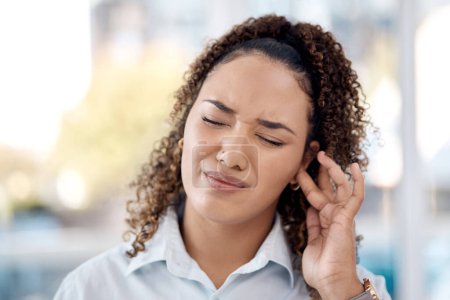 Foto de Earache, injury and woman with a hearing problem from noice, loud music and deaf. Stress, pain and business employee with tinnitus, pressure from sound and infection in the ear in the workplace. - Imagen libre de derechos