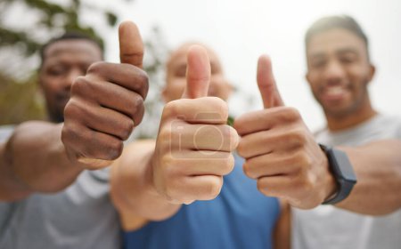Téléchargez les photos : Believing is the first step to winning. Closeup shot of a group of unrecognisable men showing thumbs up while exercising outdoors - en image libre de droit