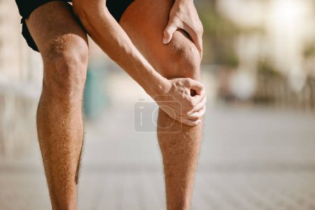Photo for Knee pain of runner or man hands for fitness healthcare risk, muscle accident or training problem in city. Running, cardio and workout legs injury of athlete person stop in street for muscle massage. - Royalty Free Image