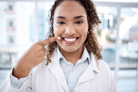 Photo for Portrait of black woman pointing to teeth whitening results, dentist medical and mouth healthcare in hospital. Professional dental doctor with tooth cleaning services and happy face in USA clinic. - Royalty Free Image
