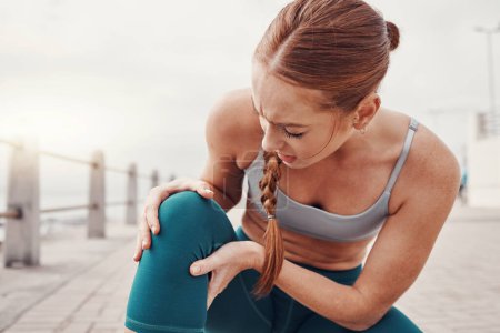 Woman holding leg, knee injury in outdoor exercise and injured joint inflammation from training. Person exercising with bruise, physical pain in muscle and athlete with medical emergency in sports.