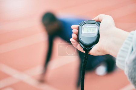 Photo for Sports, running and hands with stop watch on race track for exercise, marathon training and fitness. Stadium, workout and athlete team with timer for performance, lap speed and racing competition. - Royalty Free Image