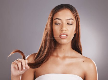Foto de Hair care, beauty salon and split ends of a black woman feeling annoyed from hairstyle. Shampoo, cosmetic and haircut of a young model with isolated gray background feeling angry in a studio. - Imagen libre de derechos