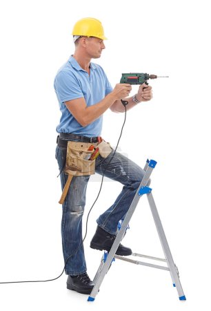 Téléchargez les photos : Happy, handyman and repairman in studio with a drill, tool belt and ladder for maintenance. Happy, smile and professional male industry worker with tools for repairs isolated by white background - en image libre de droit