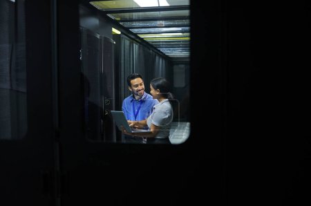Man, woman or laptop in server room, IT engineering or software programming for cybersecurity, analytics or database safety. Smile, happy or data center people on technology in teamwork collaboration.