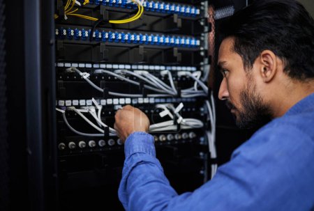 Photo for Engineer, server room and man with cable connection for software update or maintenance at night. Information technology wire, cloud computing and male programmer check database network in data center. - Royalty Free Image