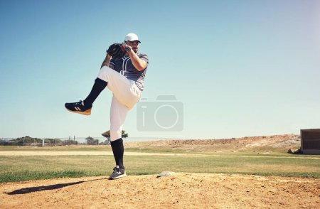 Foto de You cant coach this kind of skill. a young man pitching a ball during a baseball match - Imagen libre de derechos