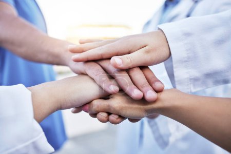 Healthcare, motivation and hands of doctors for support, partnership and medical success. Teamwork, trust and team of employees in medicine with a gesture for solidarity, commitment and goal.