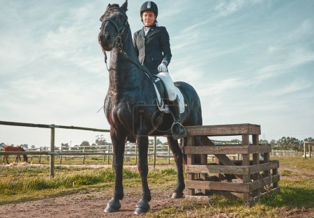 Téléchargez les photos : Sports, horse and equestrian with a woman jockey riding outdoor on a farm or ranch for horseback training. Nature, agriculture and field with a female athlete or rider on an animal for horesriding. - en image libre de droit