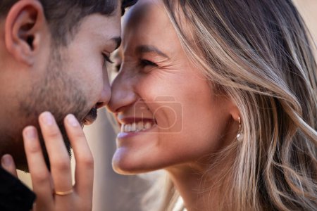 Téléchargez les photos : Couple, forehead touch and laughing together with happiness, comic moment or romance outdoor for date. Man, woman and funny time with love, care or happy in nature close up with hand, face and crazy. - en image libre de droit