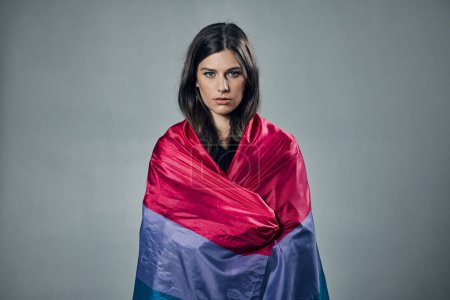 Téléchargez les photos : Bisexual flag, pride and woman in portrait, lgbtq and freedom to love, inclusion and equality, protest for human rights. Gay, trans and lesbian identity, politics and community on studio background. - en image libre de droit