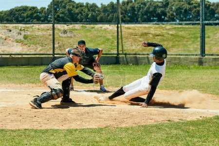 Photo for Theyre both up to the task. Full length shot of a young baseball player reaching base during a match on the field - Royalty Free Image