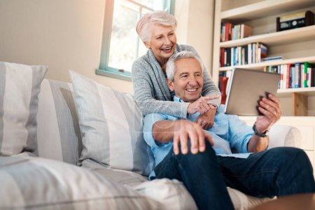 Photo for Staying informed is key to staying current. a senior couple taking selfie together on the sofa at home - Royalty Free Image