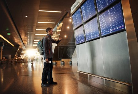 Photo for There are many flights today. Full length shot of a handsome young man looking at a board in an airport - Royalty Free Image
