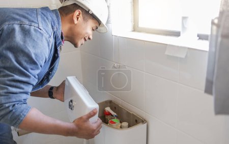 Toilet maintenance, plumber and man fix cistern, home renovation and builder service. Contractor, bathroom tank plumbing and handyman on industrial technician for leak, broken pipe and sewer drainage.