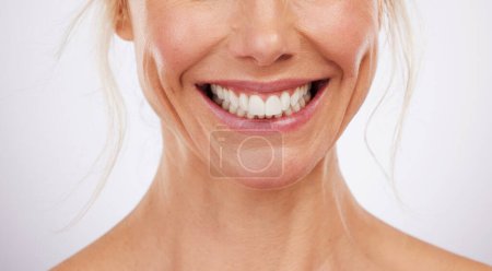 Téléchargez les photos : Teeth whitening, mouth and smile of woman in studio, beauty background and fresh mint breath. Closeup female model, clean dental and happy face of skincare wellness, tooth implant and aesthetic salon. - en image libre de droit
