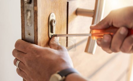 Foto de Locksmith hands, maintenance and handyman with tools, home renovation and fixing, change door locks and closeup. Construction, building industry and trade with manual labour, vocation and employee. - Imagen libre de derechos