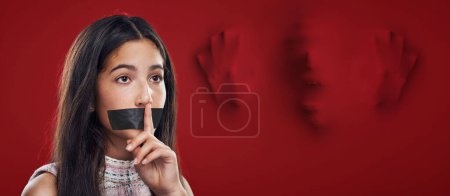 Woman silence, face tape and victim of domestic violence, sexual assault trauma or abuse crime from human trafficking. Red secret mockup, censored speech and young girl scared, fear or quiet gesture.