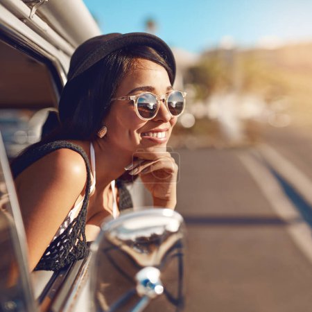 Photo for Time to travel new roads. a happy young woman leaning out of the window during a road trip - Royalty Free Image