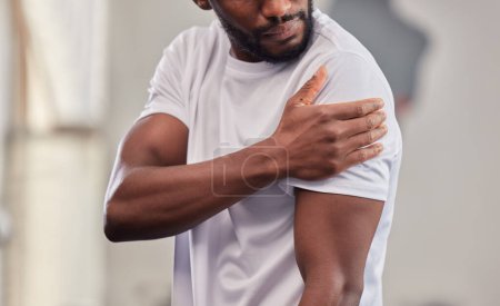 Shoulder pain, fitness and black man with injury in gym after accident, workout or training. Sports, health and male athlete with fibromyalgia, inflammation or arthritis, tendinitis or painful arm