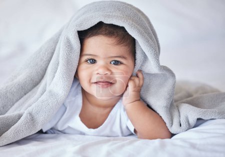Photo for Happy, comfy and portrait of a baby on a bed to relax, sleep and rest with a blanket. Smile, cute and adorable girl child lying in the bedroom for relaxation, comfort and happiness in a house. - Royalty Free Image