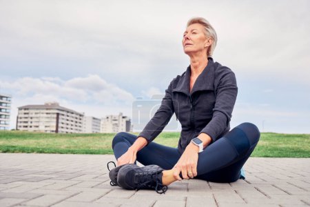 Woman, breathing and stretching exercise at park, sky mockup and ground for training in Miami. Senior female, breathe and fitness outdoor for workout, sports and meditation for healthy runner mindset.