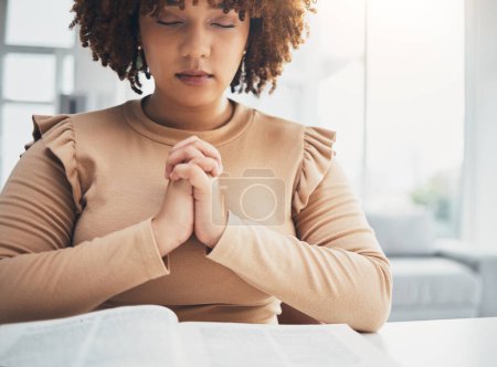 Prayer, black woman and holy book for religion, faith and god help, support and spiritual healing at home. Praying hands, hope and christian person with bible education for hope, trust and worship.