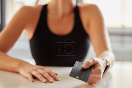Foto de Hands, credit card and payment at gym for fitness membership or exercise subscription. Fintech, ecommerce and athlete or woman buying or paying for workout or training at exercising club for health - Imagen libre de derechos