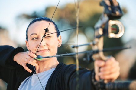 Photo for Archery bow, woman aim and shooting range for competition, game or practice at an outdoor sports or park. Hunter or person face with arrow for gaming, adventure and hunting with focus on target. - Royalty Free Image