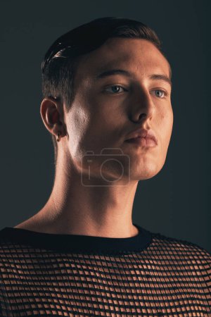 Téléchargez les photos : Gender neutral person, fashion and lgbtq gen z youth, face and beauty, edgy style on dark background in studio. Non binary, lgbt community and queer model, trendy and designer clothes with cosmetics. - en image libre de droit
