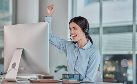 Business woman, call center and celebration for winning, promotion or sale in telemarketing at office desk. Happy female consultant or agent celebrating victory, good news or success at the workplace.