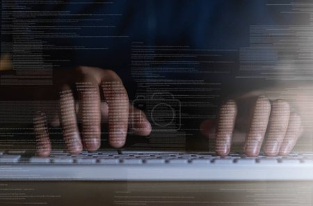 Photo for Shot of an unrecognisable hacker using a computer in the dark. - Royalty Free Image