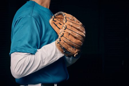 Photo for Baseball pitcher, hand and glove in studio for sport, training and throwing by black background. Man, cropped and hands for exercise, strikeout or athlete with sports, game or competition for workout. - Royalty Free Image