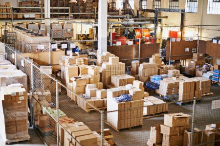Shot of the interior of a large packaging and distribution warehouse. mug #643444808