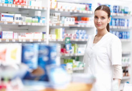 Photo for Smiling pharmacist at store. Portrait of beautiful pharmacist smiling at medical store - Royalty Free Image