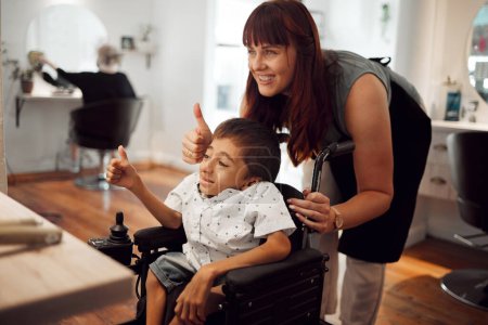 Photo for Hair salon, hairdresser and child in wheelchair with thumbs up after haircut. Hairdressing, barber and hair care for young disabled kid. Support, smile and thank you from happy special needs boy. - Royalty Free Image