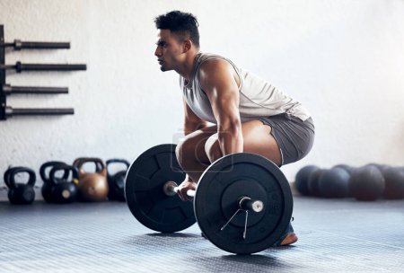 Workout, weightlifting and man doing deadlift training with strength, weights and motivation in fitness gym. Bodybuilder, sport and strong athlete doing power exercise with a dumbbell at health club.