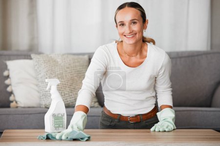 Photo for Woman cleaning home, table and living room with a chemical disinfectant soap spray bottle to clean house dirt. Adult housekeeping with a smile, family room is healthy and hygienic or germ free life. - Royalty Free Image